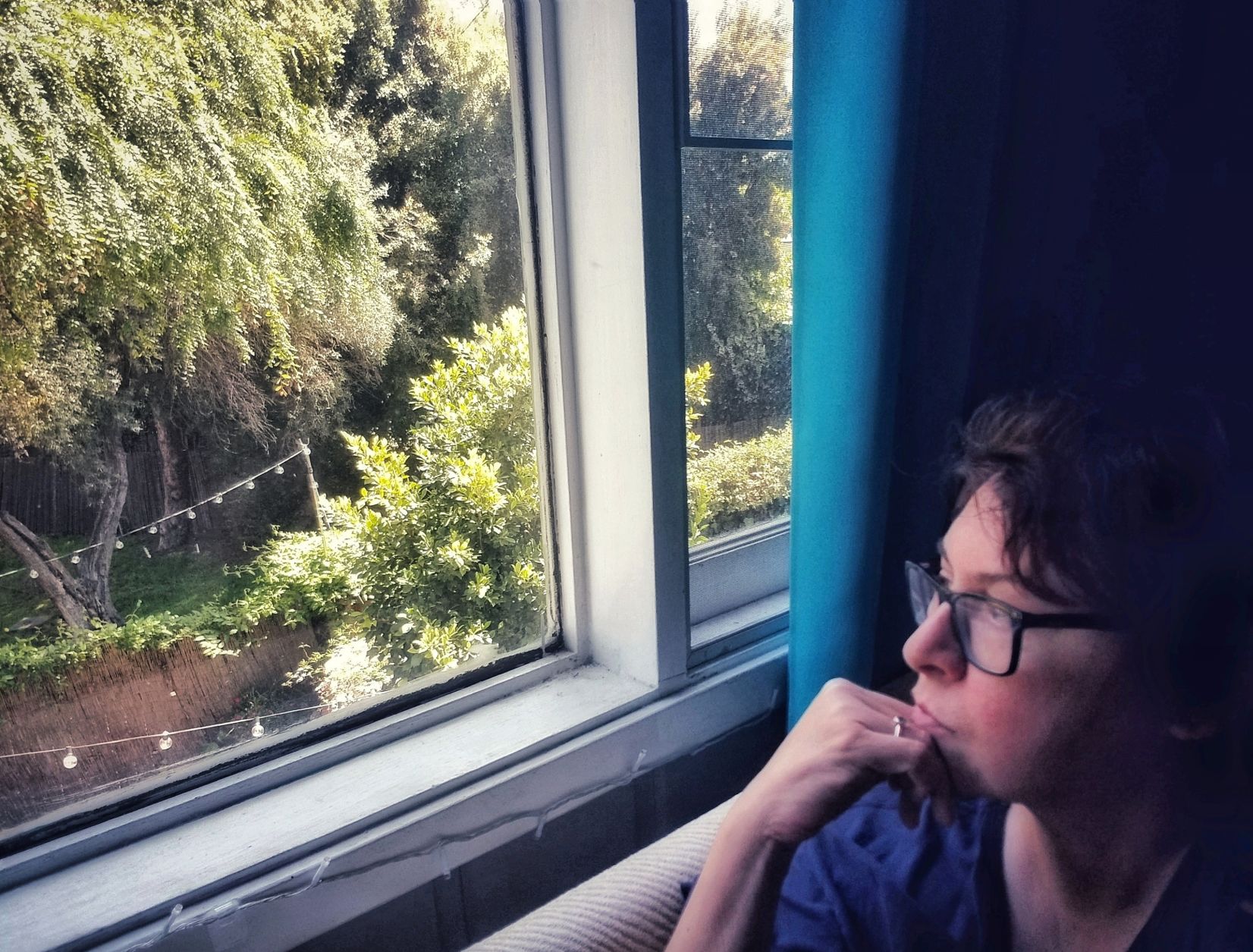 Gina Acuña staring out the window